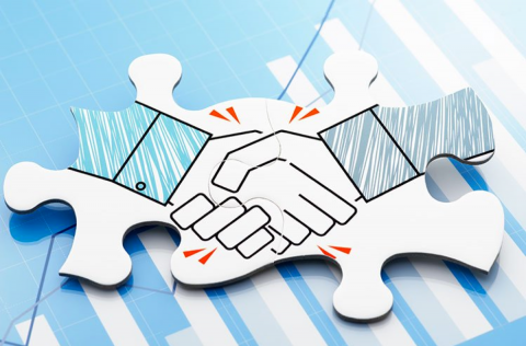 Stock photo of two puzzle pieces with shaking hands