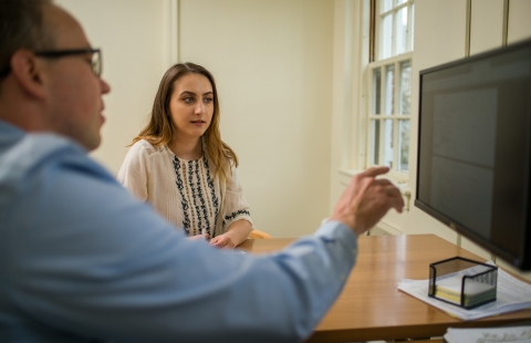 Photo of a female college student meeting with an advisor