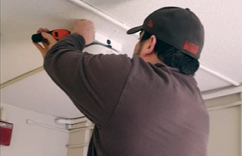 A technician installs a wireless access point