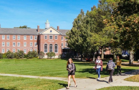 Photo of a college campus in spring with brick buildings in the background