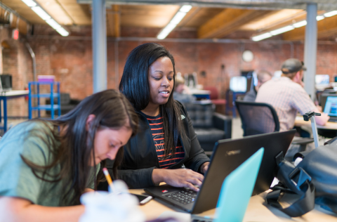 Students working together on laptops in a computer lab