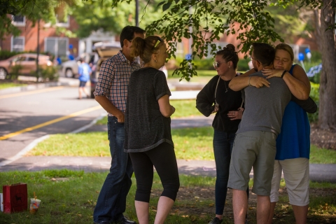 Parents hug their college students goodbye