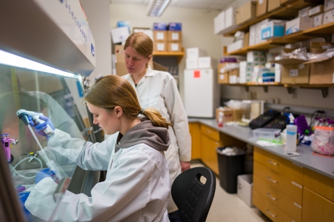 Two female college students working in a lab