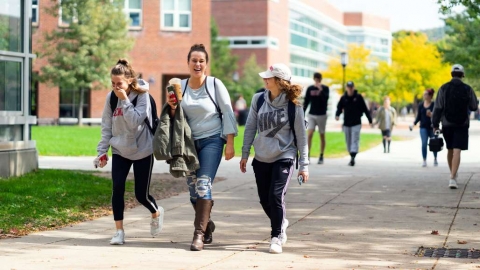 Three female college students walking outside